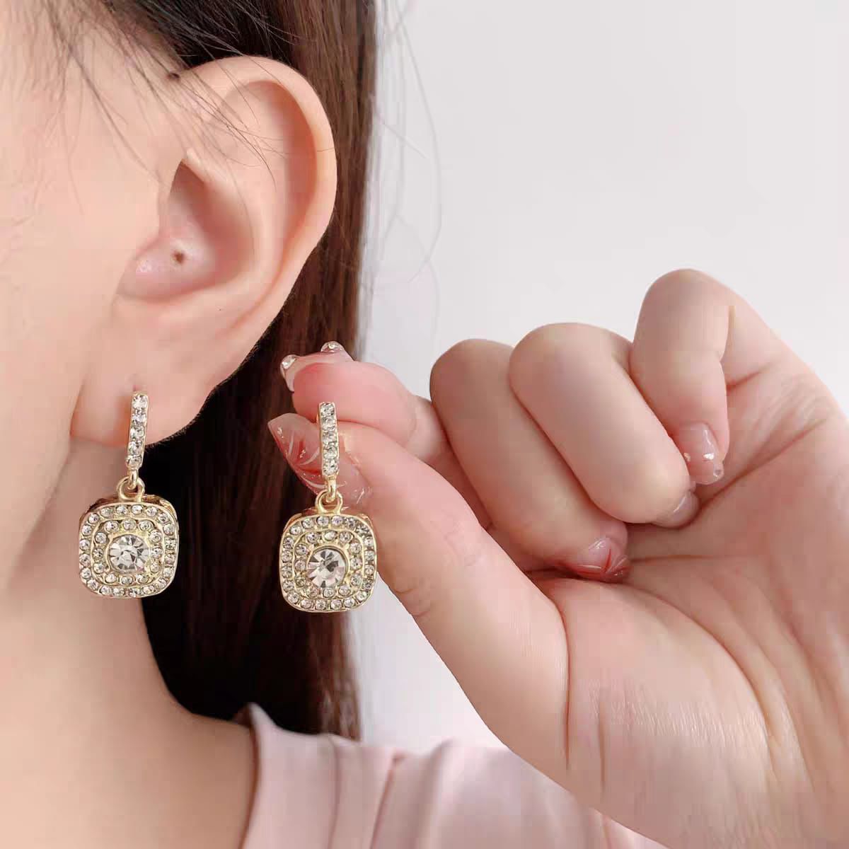 Diamond frame drop earrings.